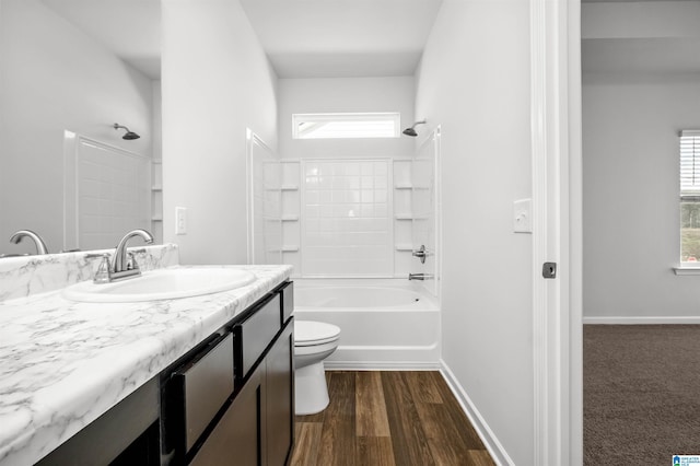 full bathroom with a wealth of natural light, shower / bathing tub combination, vanity, and toilet