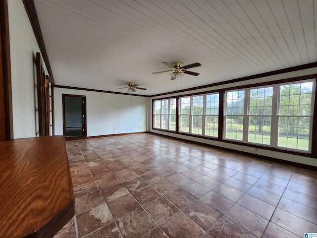 unfurnished living room with dark tile floors, ceiling fan, and ornamental molding