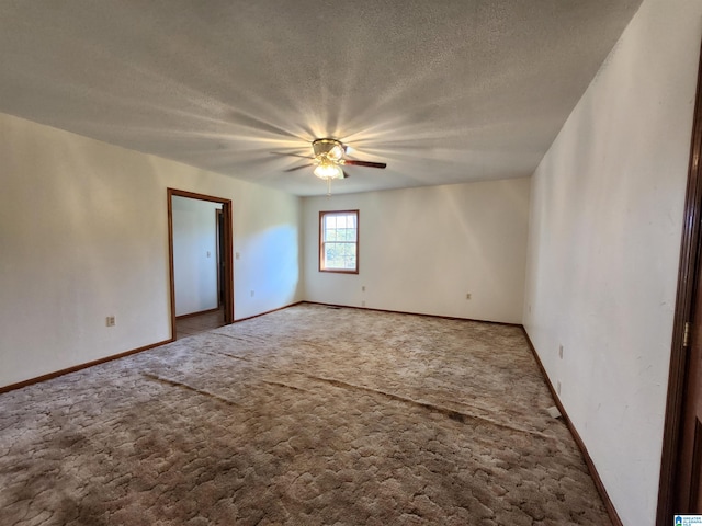 carpeted empty room with ceiling fan and a textured ceiling