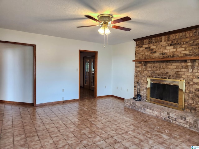 unfurnished living room with ceiling fan, tile flooring, a brick fireplace, a textured ceiling, and brick wall