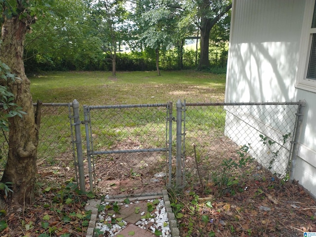 view of gate featuring a yard