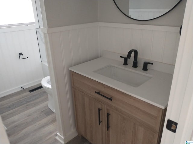 bathroom featuring vanity, toilet, and hardwood / wood-style floors