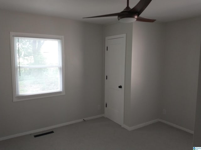 spare room with carpet and ceiling fan