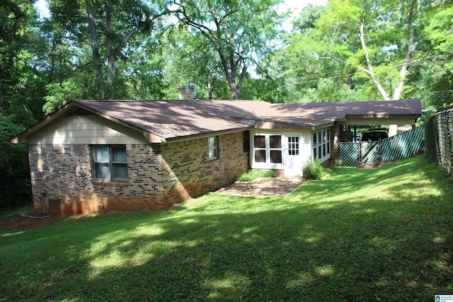 rear view of house with a lawn