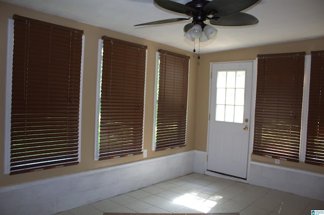 interior space with ceiling fan