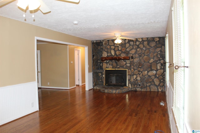 unfurnished living room with a textured ceiling, a fireplace, ceiling fan, and hardwood / wood-style floors