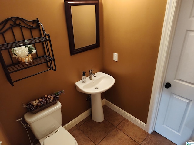 bathroom with toilet and tile patterned floors