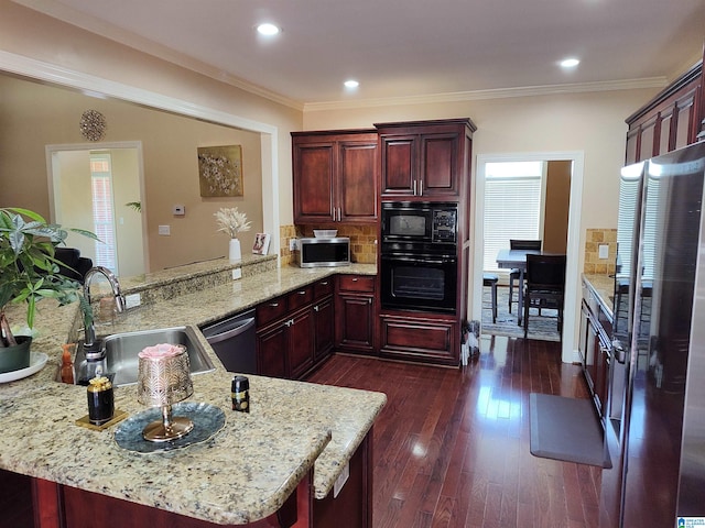 kitchen featuring sink, kitchen peninsula, crown molding, black appliances, and dark hardwood / wood-style flooring