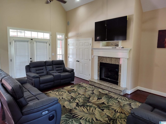 living room featuring high vaulted ceiling, a high end fireplace, ceiling fan, and dark hardwood / wood-style flooring