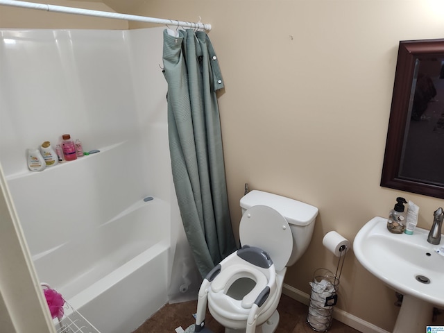 bathroom with shower / bath combo and toilet