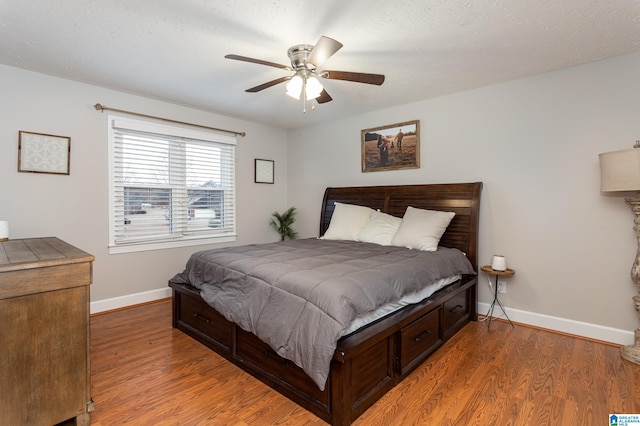 bedroom with ceiling fan and light hardwood / wood-style floors