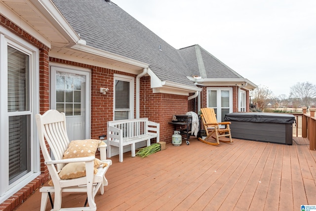 wooden deck featuring a hot tub