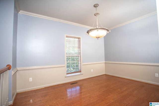 unfurnished room featuring crown molding and wood-type flooring