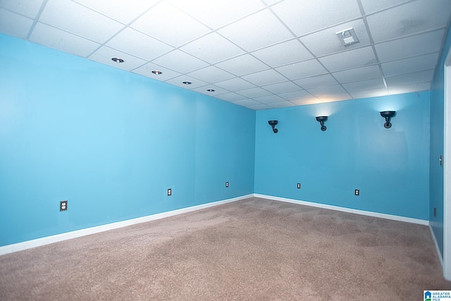 spare room featuring carpet floors and a drop ceiling