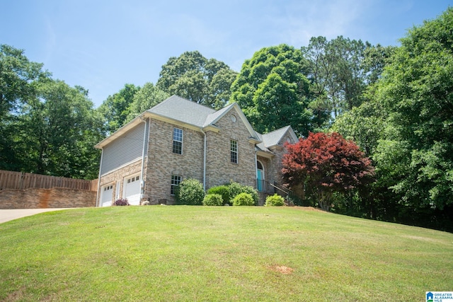 view of front of home with a garage and a front yard