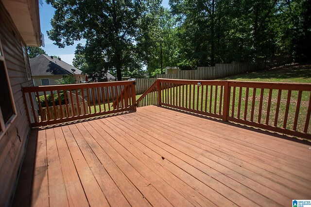 wooden terrace featuring a yard