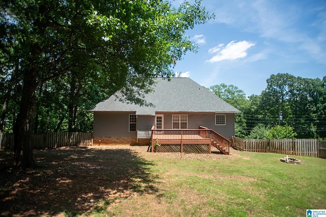 back of property featuring a lawn and a wooden deck