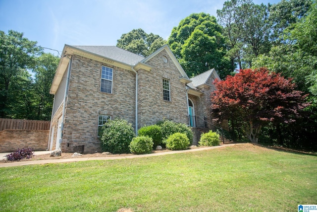 view of front of property featuring central AC unit and a front lawn