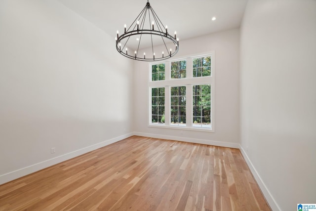 interior space with a notable chandelier and light wood-type flooring