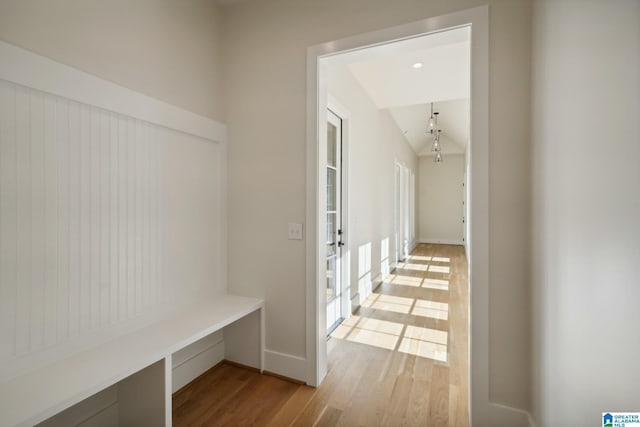 mudroom with plenty of natural light, light wood-type flooring, and lofted ceiling