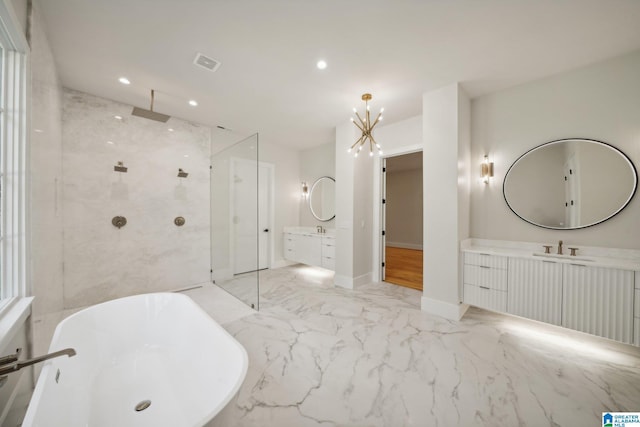 bathroom with vanity, an inviting chandelier, and independent shower and bath