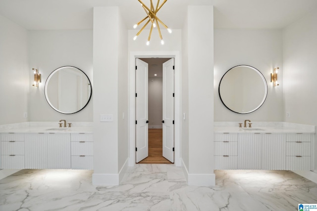 bathroom featuring vanity and a notable chandelier