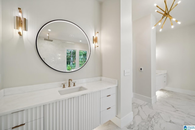 bathroom featuring a notable chandelier and vanity