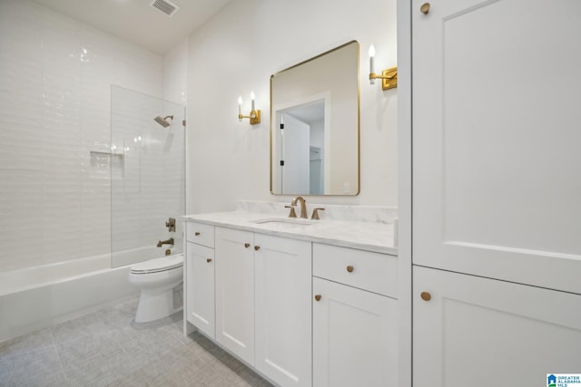 full bathroom with vanity, tiled shower / bath combo, tile patterned floors, and toilet