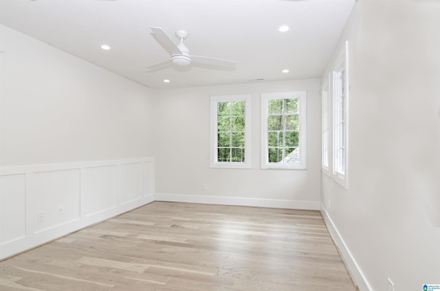 unfurnished room with ceiling fan and light wood-type flooring