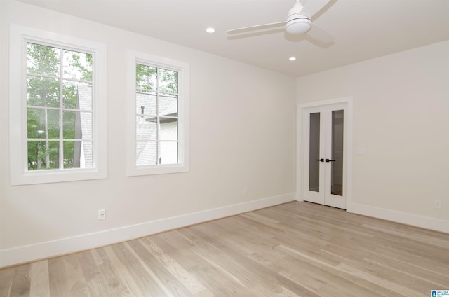 spare room with ceiling fan, light hardwood / wood-style flooring, and french doors