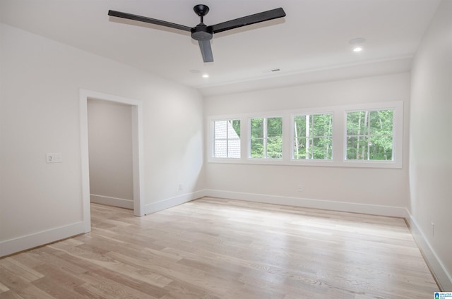 spare room with ceiling fan and light wood-type flooring