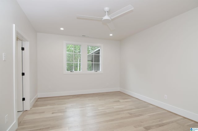 spare room featuring ceiling fan and light hardwood / wood-style flooring