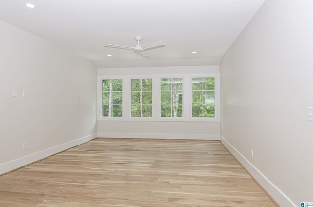 spare room with ceiling fan, a healthy amount of sunlight, and light hardwood / wood-style flooring