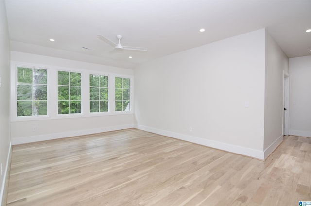 spare room featuring light hardwood / wood-style floors and ceiling fan