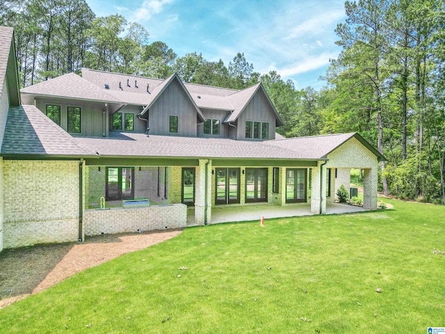 back of property featuring a yard and a patio