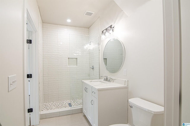 bathroom with tile patterned floors, vanity, toilet, and an enclosed shower