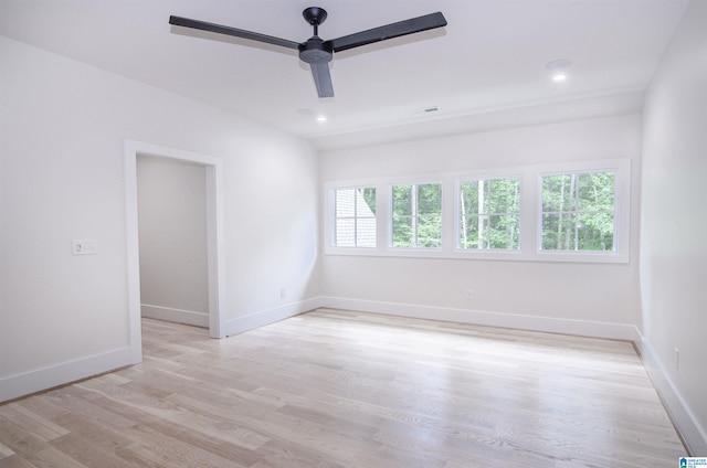 unfurnished room featuring plenty of natural light, ceiling fan, and light hardwood / wood-style floors