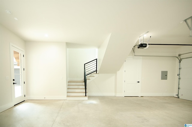 garage featuring electric panel and a garage door opener