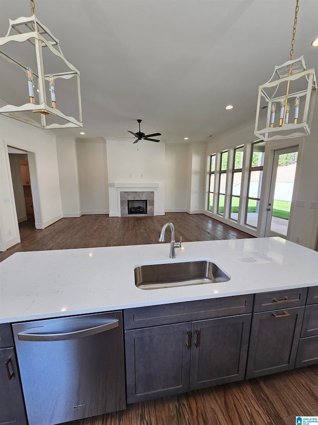 kitchen featuring sink, dark wood-type flooring, pendant lighting, and stainless steel dishwasher