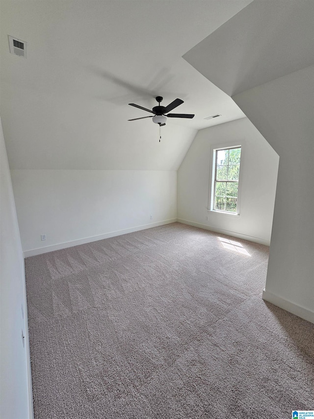additional living space with ceiling fan, carpet floors, and lofted ceiling