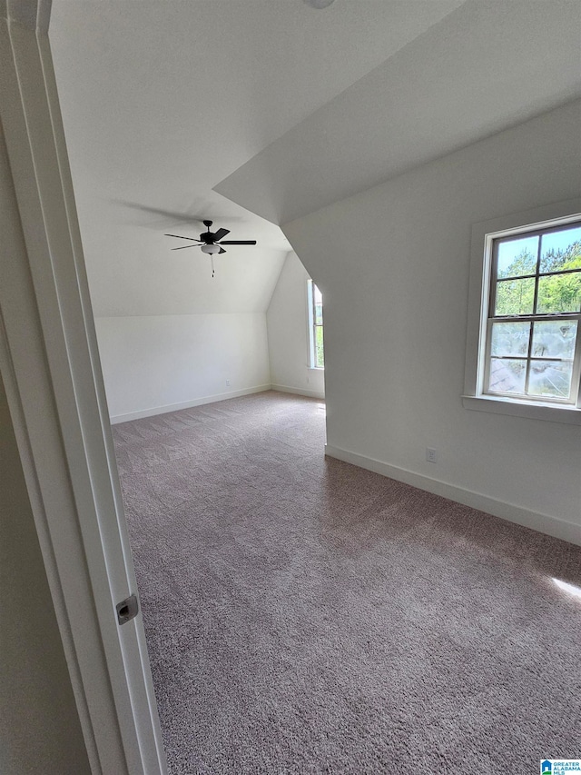 bonus room with carpet flooring, lofted ceiling, and ceiling fan