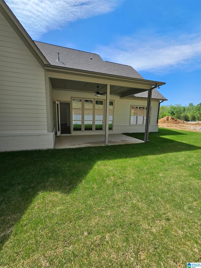 rear view of house with a patio area, ceiling fan, and a yard