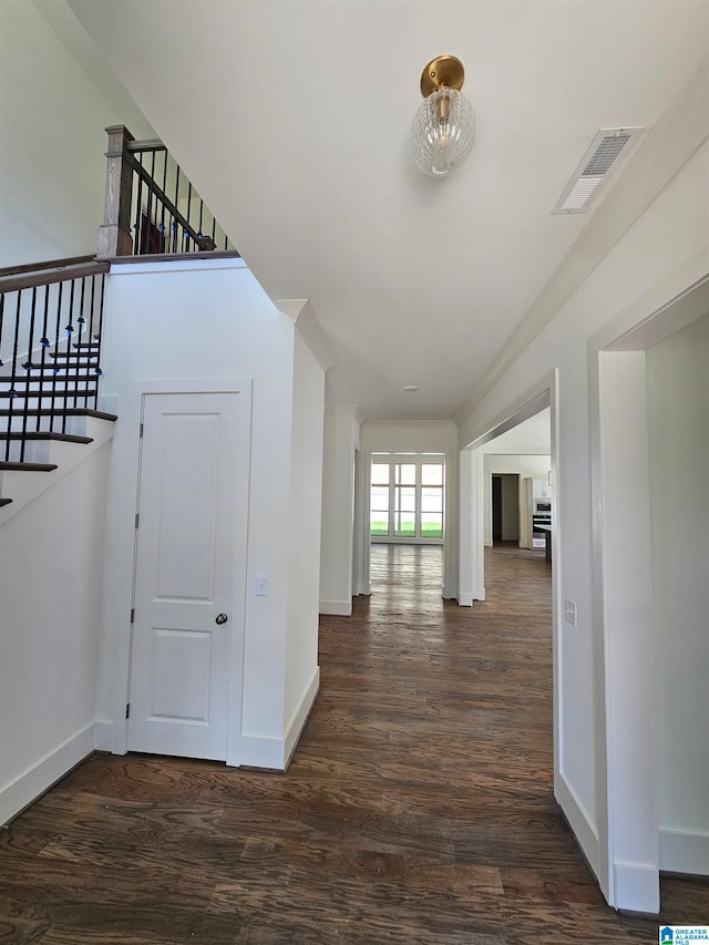 hallway with dark hardwood / wood-style flooring