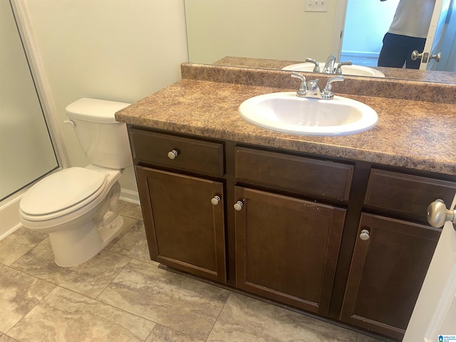 bathroom featuring vanity, toilet, and tile floors