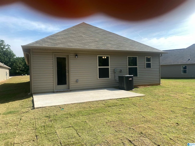 back of house featuring a patio, central AC unit, and a yard