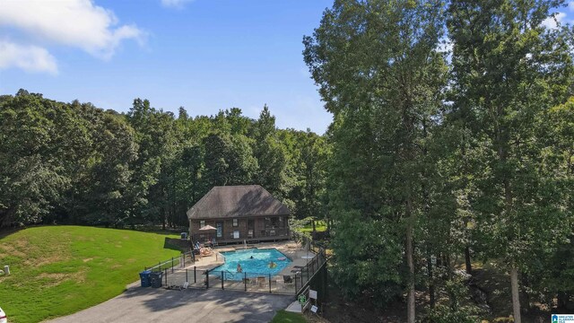 8611 Shady Trl, Helena, AL 35022 - view of swimming pool with a yard, an outbuilding, an exterior structure, a patio, and a wooded view
