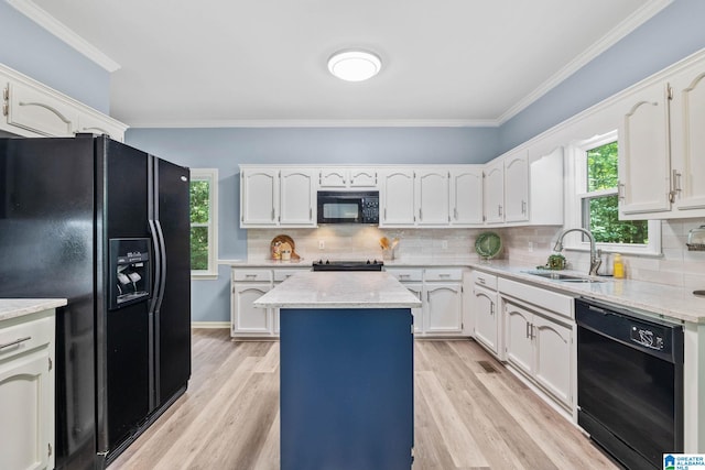 kitchen with sink, a center island, ornamental molding, black appliances, and white cabinets