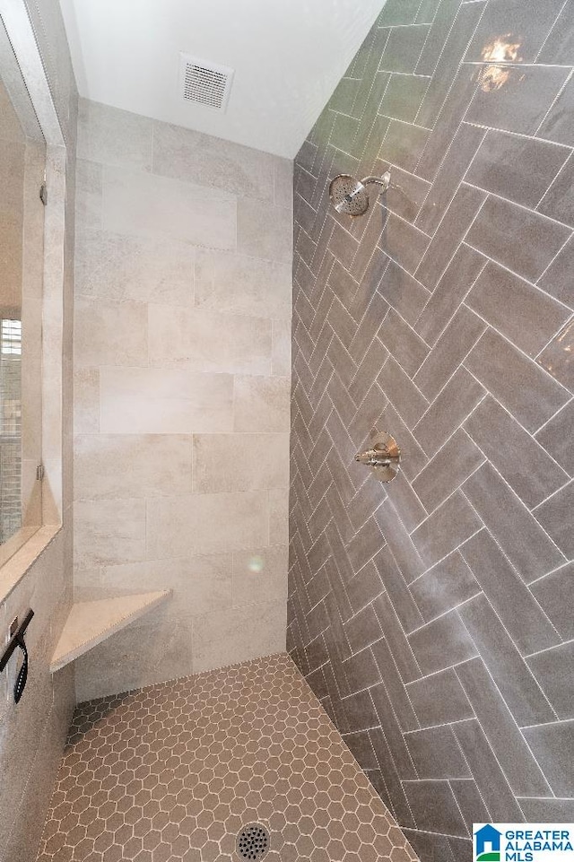 bathroom with tiled shower