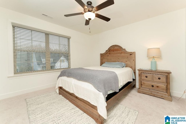 bedroom featuring ceiling fan and light carpet