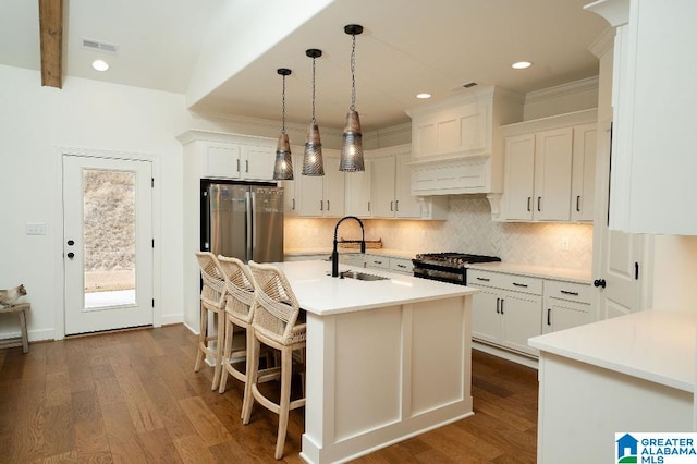 kitchen with dark hardwood / wood-style floors, white cabinetry, sink, and stainless steel appliances